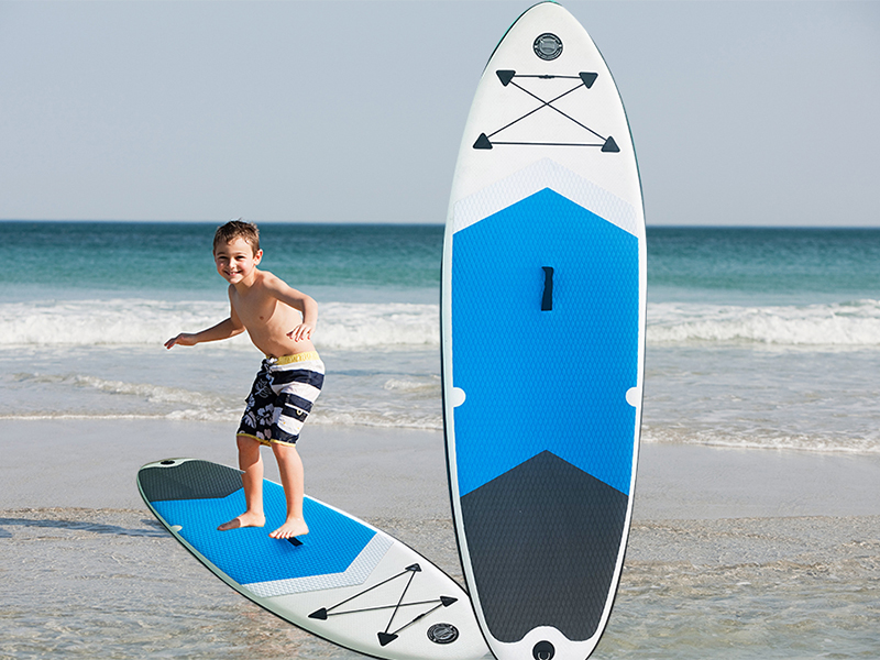Young boy surfing in shallow water